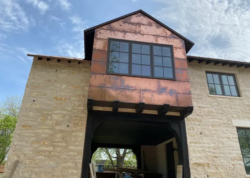 Copper metal panel facade on a stone building for Roof Repair in Schriever