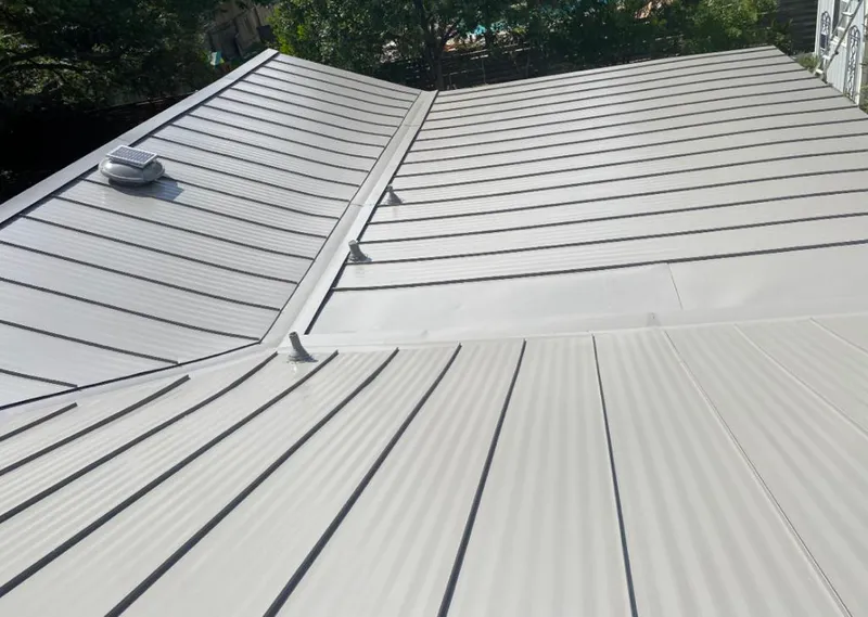 Solar attic fan installed on a metal roof for Roof Ventilation in Schriever